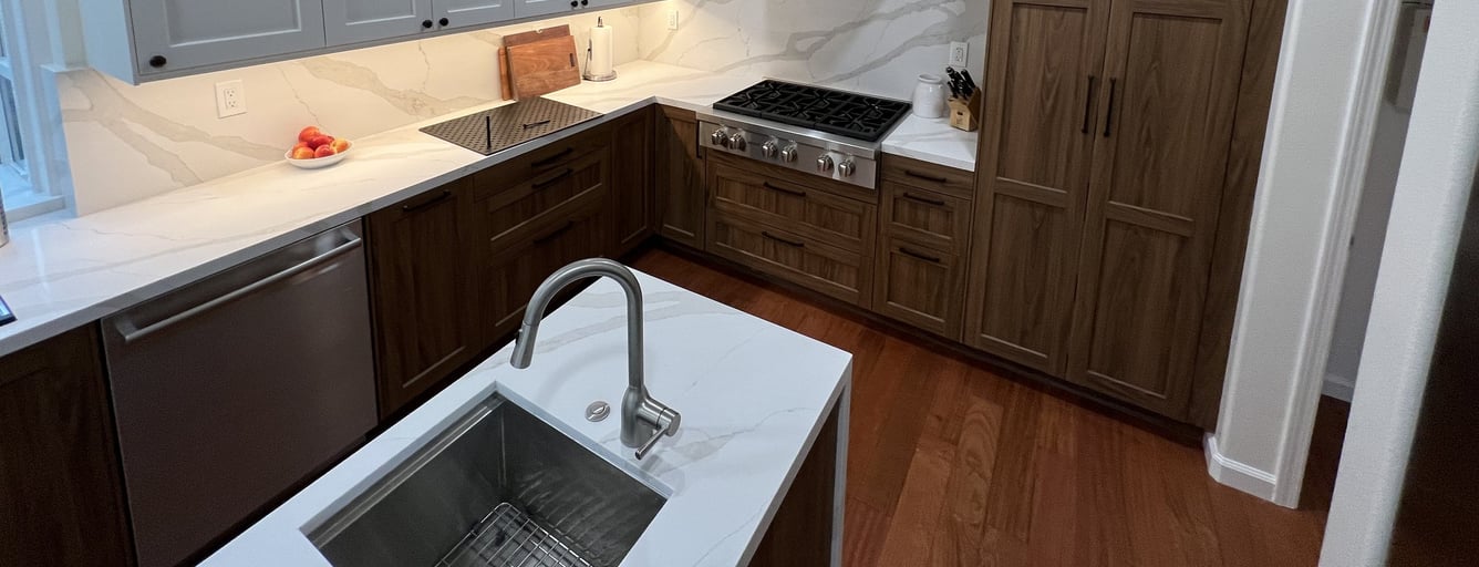 Kitchen with freshly painted light gray upper cabinets and wood lower cabinets