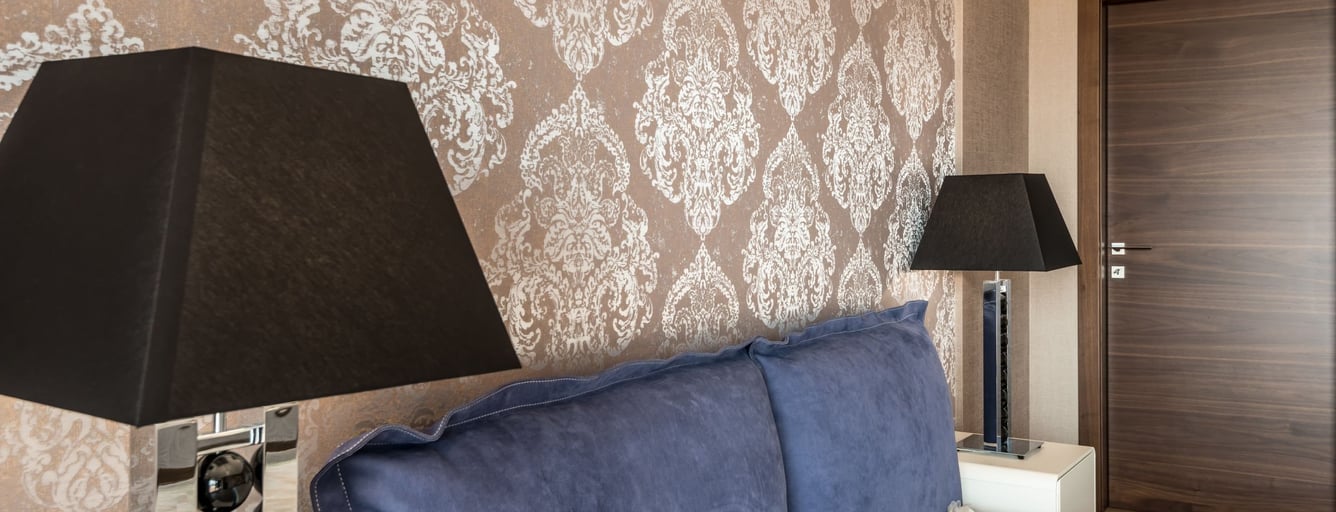 Bedroom feature wall with gold damask wallpaper