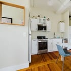Apt 201 kitchen with dining table and stainless appliances