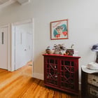 Hallway in Apartment 301 with hardwood floors and a view into the living room