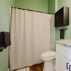 Apartment 303 bathroom vanity with round mirror and walk-in shower