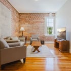 Apartment 303 sitting area with armchairs and window