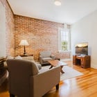 Apartment 303 sitting area with television and doorway to the bedroom