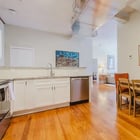 Apartment 303 kitchen counter and dining table with upholstered chairs