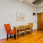 Apartment 303 dining table with orange and gold upholstered chairs