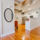 Apartment 303 hallway with oval mirror looking toward the kitchen