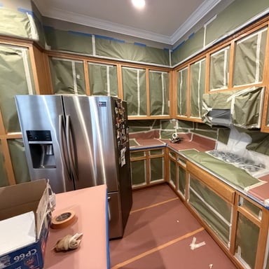 Kitchen masked off with plastic before cabinet spraying