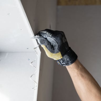 Drywall seam being taped and mudded