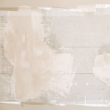 Wall with fresh drywall patches before painting