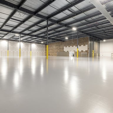 Glossy white epoxy floor in a large warehouse