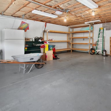Clean residential garage with a sealed concrete floor
