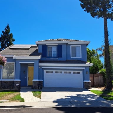 Blue two-story home after exterior painting