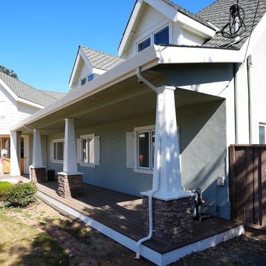 Craftsman porch with gray siding and white columns