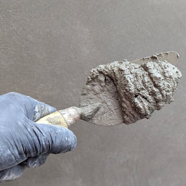 Trowel applying plaster to a wall