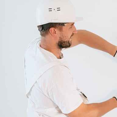 Installer smoothing a strip of wallpaper