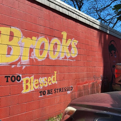 The side wall painted with Brooks and Too Blessed To Be Stressed in yellow