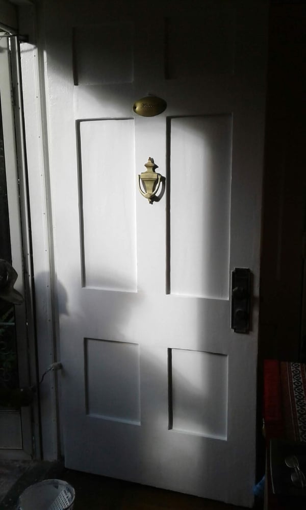 The same door stripped, smoothed, and repainted white