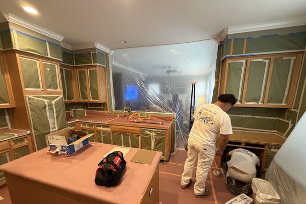 Diaz crew prepping kitchen cabinets for spraying