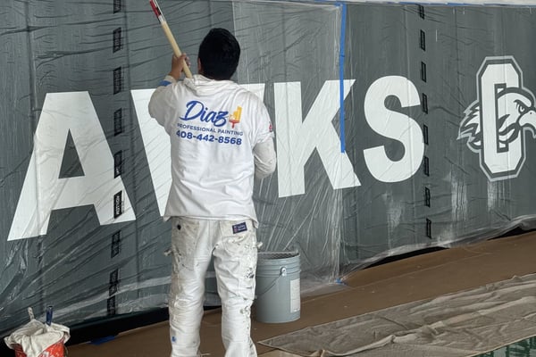 Diaz painter rolling a school gym wall