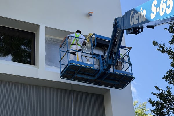 Diaz crew painting from a boom lift
