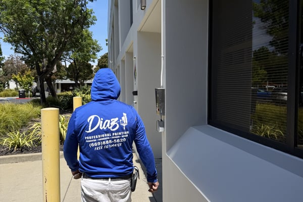 Diaz painter walking past a freshly painted office building