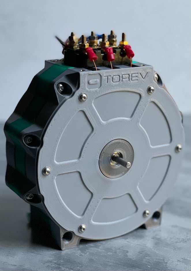 Torev axial flux motor prototype viewed from above, showing oil cooling manifold and high-voltage connections