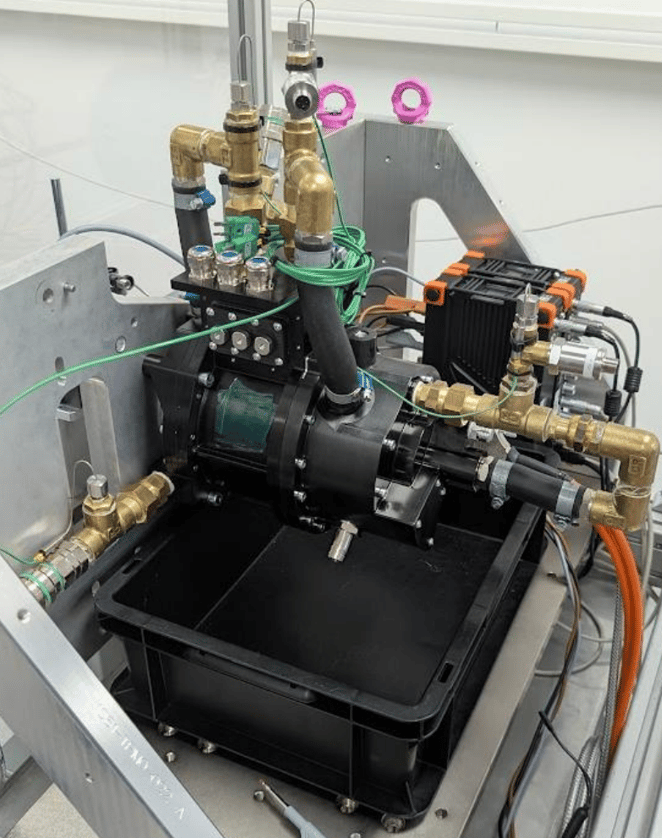 Torev motor mounted on a test rig with oil cooling plumbing and instrumentation cables