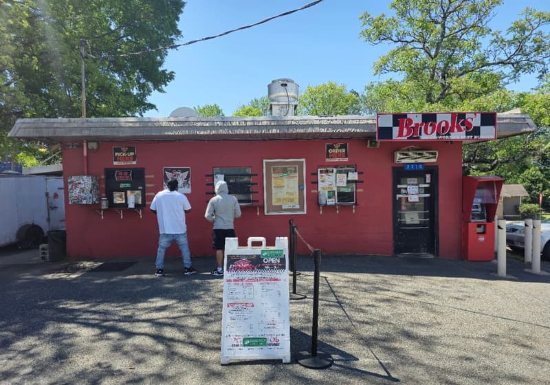 Customers lined up at the walk-up windows of the red stand