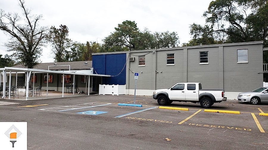 Commercial building repainted in gray with a blue accent wall