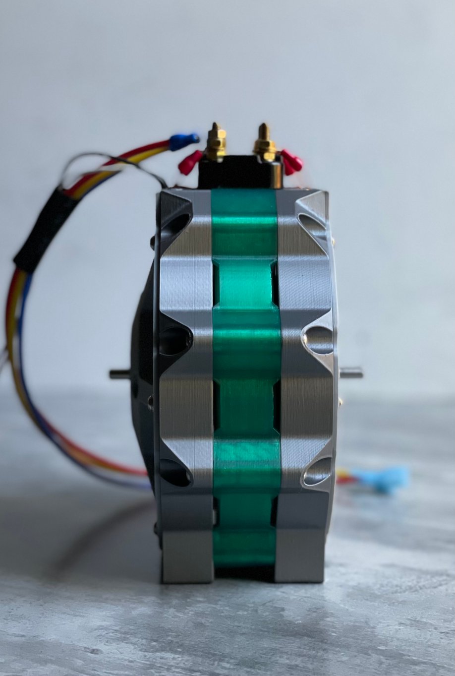 Engineer routing wires through a Torev electric motor prototype during assembly